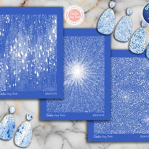 May include: A collection of blue and white clay tools and earrings. The tools feature various white patterns on a blue background, including a rain-like design, a burst, and a floral-like pattern. The earrings have matching designs. The text "Goto Clay Tools" and "SS#1215, SS#1216, SS#1217" are visible.