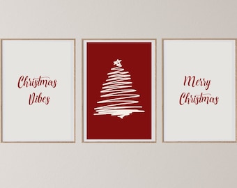 May include: Three framed Christmas-themed art prints. The left print says "Christmas Vibes" in red script on a white background. The center print has a white tree design on a red background. The right print says "Merry Christmas" in red script on a white background.