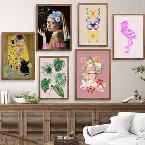 May include: A collection of six framed prints with various designs. The prints include a painting of a woman with a pearl earring, a painting of a couple kissing, a floral design, a tropical leaf design, a flamingo, and a butterfly design. The prints are hung on a white wall above a wooden cabinet and a white couch.
