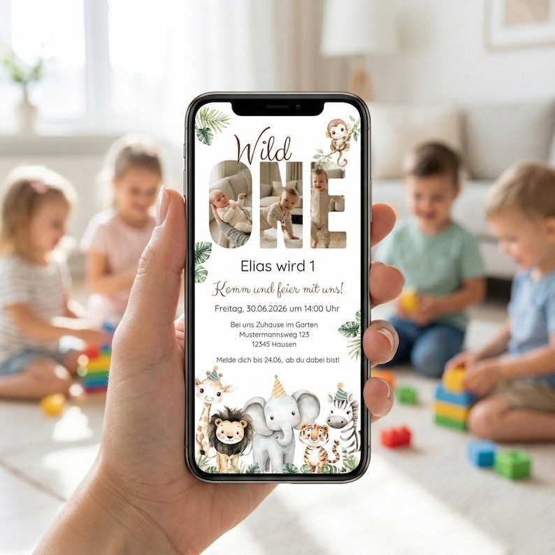 May include: A smartphone displays a birthday invitation with the text "Wild One" and "Elias wird 1." The invitation features a jungle theme with illustrations of animals like a giraffe, lion, elephant, and zebra. The background shows children playing.
