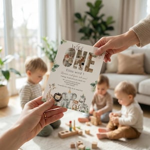 May include: A birthday invitation with the words "Wild One" and the name "Elias" printed on it. The invitation features a photo and illustrations of jungle animals. The invitation is held by a person in front of a group of children.