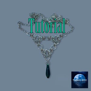 May include: A silver chainmail necklace with a teardrop-shaped pendant. The pendant is a dark green color. The necklace is in the shape of a triangle. The text "Tutorial" is written in green letters on the image.