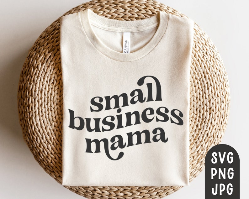 May include: Cream-colored t-shirt with the words "small business mama" in a bold, black, retro font. The shirt is displayed on a woven, circular surface. The image also includes SVG, PNG, and JPG file type icons.