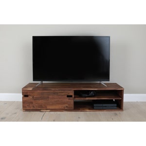 Zuma walnut tv cabinet with TV on it