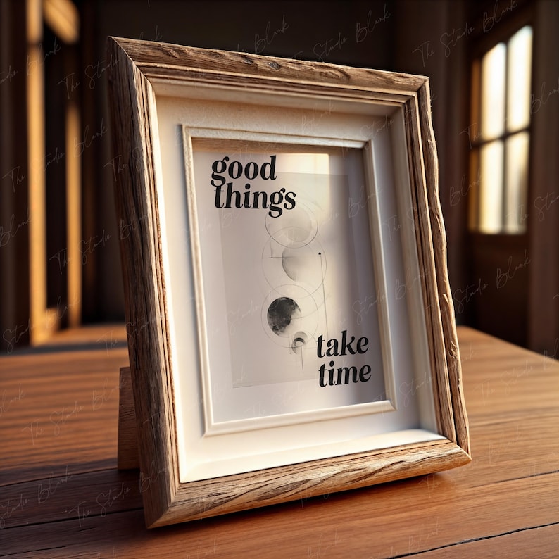 May include: A wooden picture frame with a white mat and a black and white print that says "good things take time". The print features a geometric design with circles and lines.
