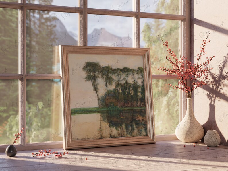 May include: A framed painting of a landscape with trees and a lake, hanging on a wall next to a window. The window is open and there are red berries in a vase on the windowsill.