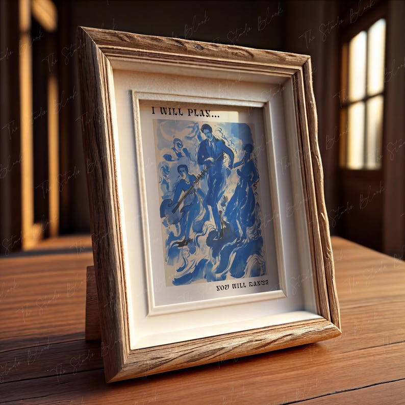 May include: A wooden picture frame with a white mat and a blue and white abstract painting inside. The painting depicts figures in a swirling blue background. The text "I will play... You will dance" is printed below the painting.