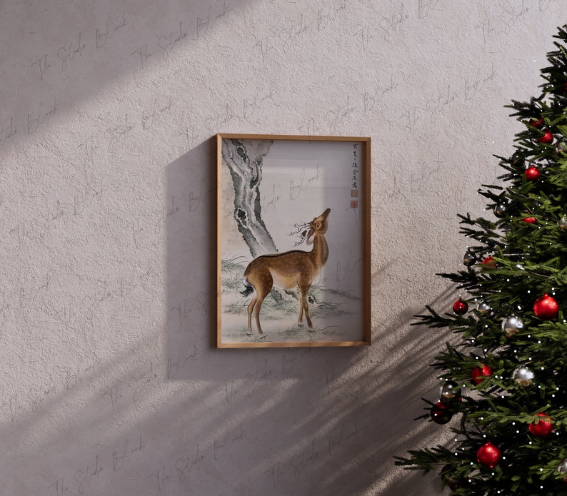 May include: A framed black and white ink drawing of a deer standing in a forest. The deer is looking up at a tree branch. The drawing is on a white background.