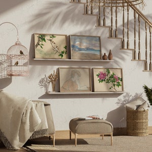 May include: An interior scene featuring framed botanical and landscape art, a decorative birdcage, and a neutral-toned seating area. The artwork includes images of birds, flowers, and a coastal scene. A woven basket and a set of stairs are also visible.
