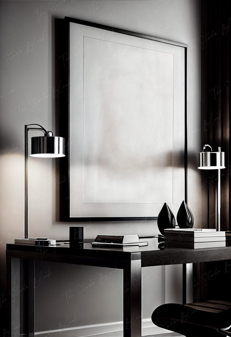 May include: A black desk with a black chair, two lamps, and a large framed picture. The desk has a black surface and a black frame. The chair has a black seat and a black back. The lamps have black bases and black shades. The picture has a black frame and a white background.