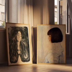 May include: Two framed portraits of women, one in black and white with a dark background, the other in color with a light blue background.