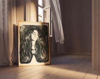 Könnte beinhalten: Ein gerahmter Schwarzweißdruck einer Frau mit langen, wallenden Haaren. Der Druck ist in einem goldenen Rahmen und lehnt an einer weißen Wand.