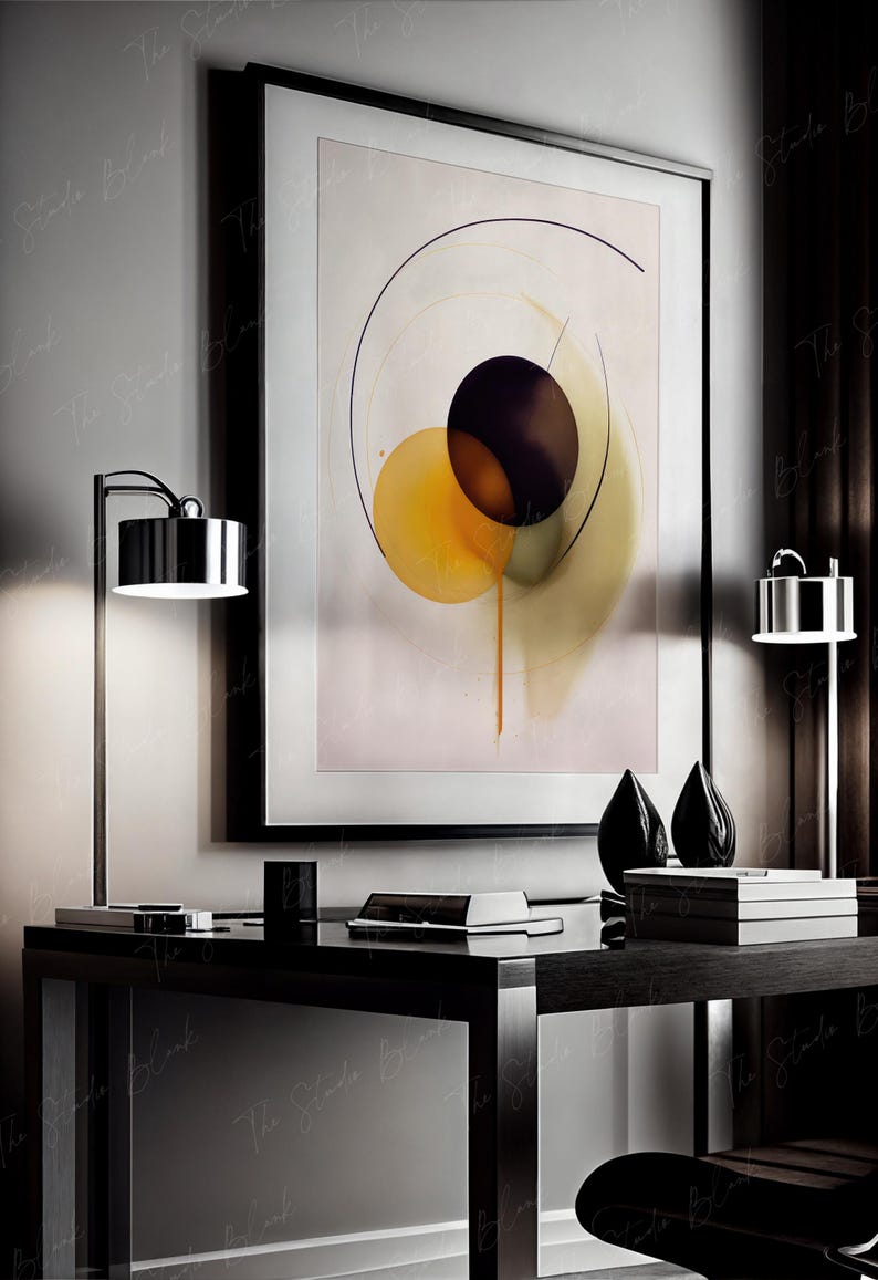 May include: A black framed abstract painting with a white background and three overlapping circles in shades of yellow, green, and purple. The painting is hanging on a wall above a black desk with a lamp and two decorative objects.