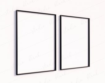 May include: Two black picture frames hanging on a white wall. The frames are empty and ready for artwork.
