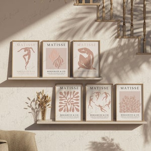 May include: Six framed art prints with a pink and white color scheme. The prints feature abstract designs and the text "MATISSE" and "BERGGRUEN & CIE".