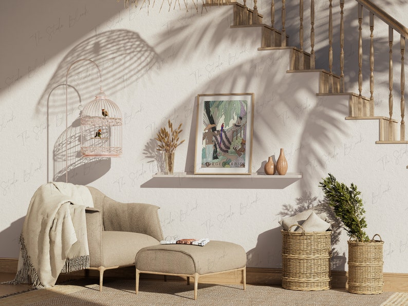 May include: A living room interior with a beige armchair, a beige ottoman, a birdcage with two birds, a framed print of a jungle scene, a shelf with a vase of dried flowers, and two wicker baskets with pillows.