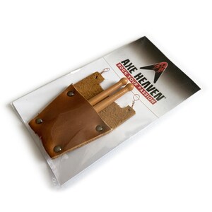 Puede incluir: Un porta baquetas de cuero marr&oacute;n con dos baquetas de madera en su interior. El porta baquetas tiene una solapa que se cierra con un broche a presi&oacute;n. El embalaje tiene el texto "Axe Heaven Rock Your Passion".