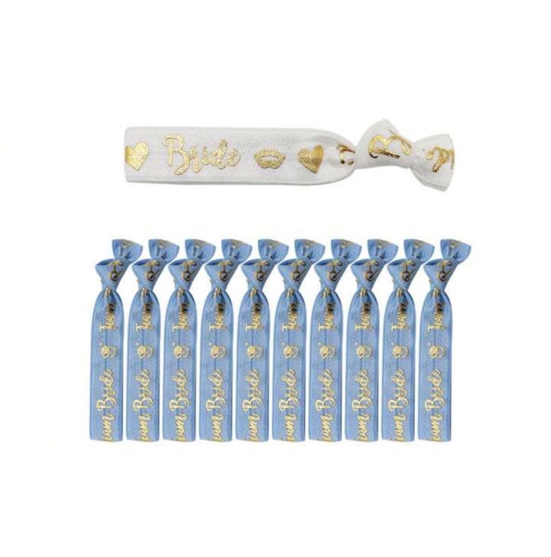 May include: Set of 11 blue and white elastic hair ties with gold foil lettering that says "Bride" and other bridal-themed designs.