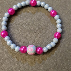 Baby blue and pink stretch bracelet with flowered accent bead