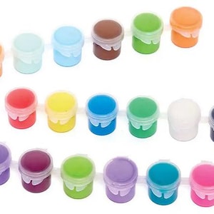 May include: A collection of small, colorful paint pots with white lids. The paint colors include orange, light blue, blue, brown, green, red, yellow, teal, white, black, purple, magenta, and pink. Ideal for arts and crafts.