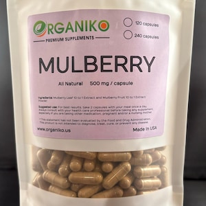 May include: A white resealable bag with a label that reads "ORGANIKO PREMIUM SUPPLEMENTS MULBERRY All Natural 500 mg/capsule" and "Ingredients: Mulberry Leaf 10 to 1 Extract and Mulberry Fruit 10 to 1 Extract Powder." The bag contains a large quantity of brown capsules.