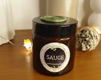 Peut inclure: Un bocal en verre brun avec un couvercle noir et une étiquette blanche qui dit "SAUGE" et "AuGrenlerDuChat". Le bocal est posé sur une surface en bois.