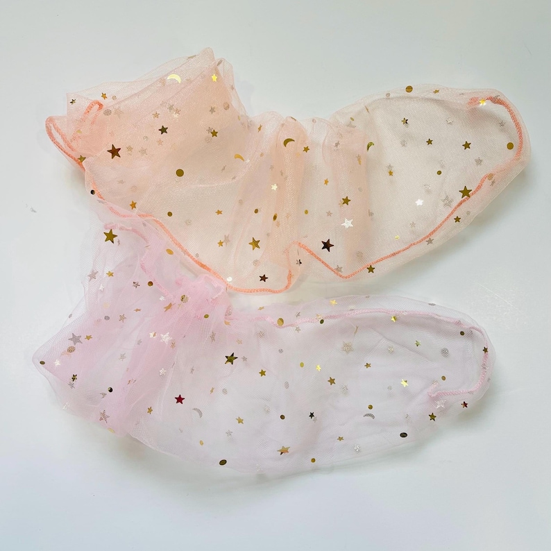 Puede incluir: Dos capas de tul transparente rosa y melocot&oacute;n con estrellas y lunas doradas brillantes. La tela es suave y delicada, perfecta para manualidades o decoraci&oacute;n.