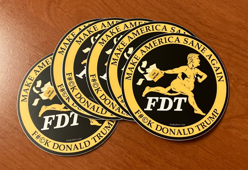 May include: A set of five round stickers with a black background and a yellow border. The stickers feature a cartoon image of a nude man running with a bag of papers labeled "Top Secret". The text on the stickers reads "Make America Sane Again" and "FDT F#OK Donald Trump".