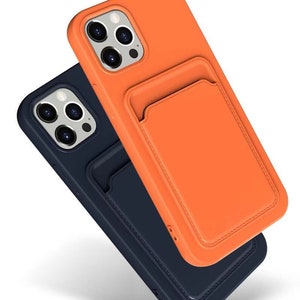 May include: Two phone cases, one orange and one navy blue, with a card holder on the back. Both cases have a textured leather-like finish.