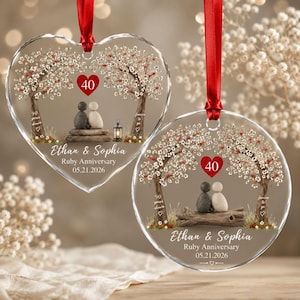 May include: Two clear acrylic ornaments, one heart-shaped and one circular, each featuring a printed design of two pebble figures sitting under flowering trees. The text reads Ethan & Sophia, Ruby Anniversary, 05.21.2026, 40, 40 years down, and forever to go.