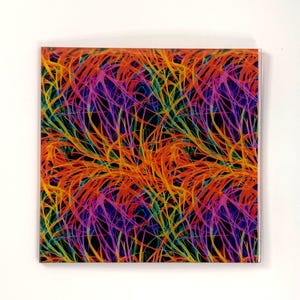 May include: Square decorative tile with a vibrant abstract design. The pattern features interwoven lines in shades of orange, yellow, pink, purple, and green against a black background. The tile has a glossy finish and a clear edge.