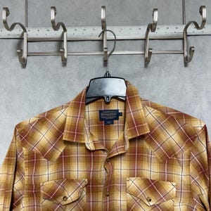 May include: A white ceramic mug with a black handle and the text "But first, coffee" in a handwritten style. The mug is on a white surface. The mug is 4 inches tall.