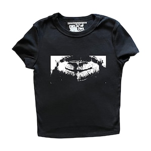 May include: Black t-shirt with a white graphic of a dental X-ray. The shirt has a crew neck and short sleeves. The text "DECAYEDCEREBRUM" is printed above the graphic in white.