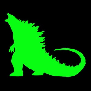 以下が含まれることがあります： とげとげの背と長い尻尾を持つゴジラのようなモンスターの緑色のシルエット。モンスターは口を開けて吠えている。