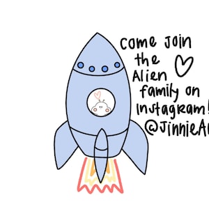 May include: A blue rocket ship with a white alien inside the window. The rocket is taking off with a red and yellow flame. The text says "Come join the Alien family on Instagram! @JinnieArts"