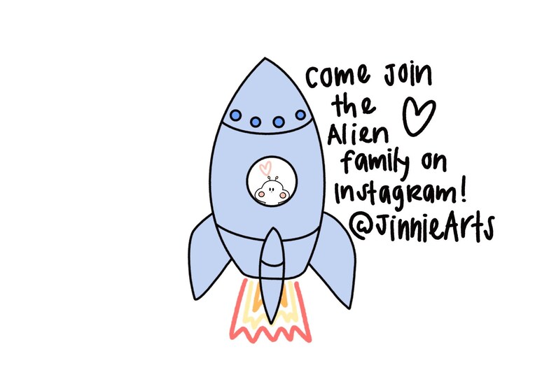 May include: A blue rocket ship with a white alien inside the window. The rocket is taking off with a red and yellow flame. The text says "Come join the Alien family on Instagram! @JinnieArts"