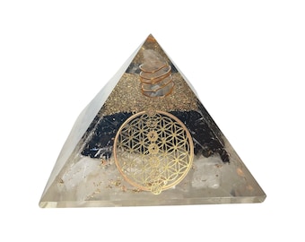 May include: A clear quartz crystal pyramid with a black obsidian layer and a gold flower of life symbol. A gold wire coil is embedded in the top of the pyramid.