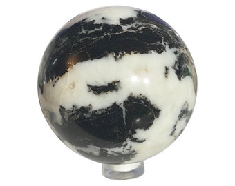 May include: A black and white marble sphere on a clear stand. The sphere has a swirling pattern of black and white.