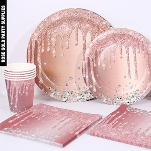 May include: Rose gold party supplies featuring a drip design and glitter. The set includes plates, napkins and cups.