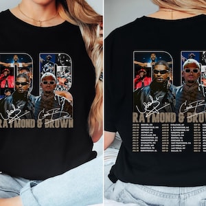 May include: Black t-shirt featuring a graphic of two men with sunglasses, the text "RAYMOND & BROWN" and a tour schedule. The design is in a collage style with the letters "DB" in the background.