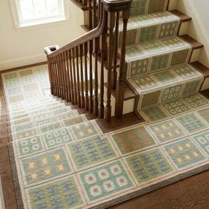 May include: A staircase with a patterned carpet runner and a wooden handrail. The carpet features a repeating geometric design in shades of green, blue, and peach. The wooden handrail and steps are a dark brown color.