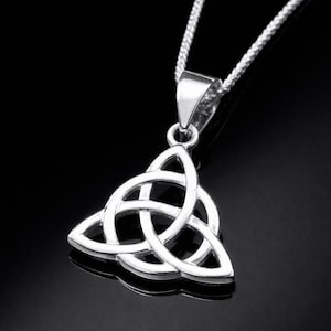 May include: A polished silver-tone metal pendant featuring a triquetra knot design, suspended from a matching silver-tone chain. The pendant has a triangular shape with three interconnected loops, showcasing a smooth, reflective metallic finish.