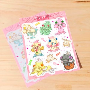 Puede incluir: Dos hojas de pegatinas con personajes de postres de dibujos animados. Las pegatinas representan criaturas con tem&aacute;tica de helado en tonos rosa, amarillo, verde y gris. El texto "Alcremie Desert cute stickers" es visible en la hoja superior.