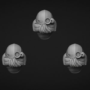 Puede incluir: Cinco cabezas de casco en miniatura de color gris idénticas dispuestas en un patrón. Cada casco presenta una parte superior redondeada y lisa, una ranura de visera horizontal, una lente circular en el lado izquierdo y un respirador texturizado.