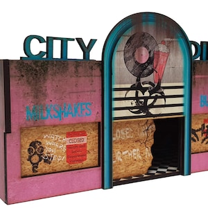 May include: A pink and blue model of a retro diner with the words "CITY DINER" on the front. The diner has a sign that says "MILKSHAKES" and another that says "BURGERS". The diner has a broken window and a sign that says "CLOSED".