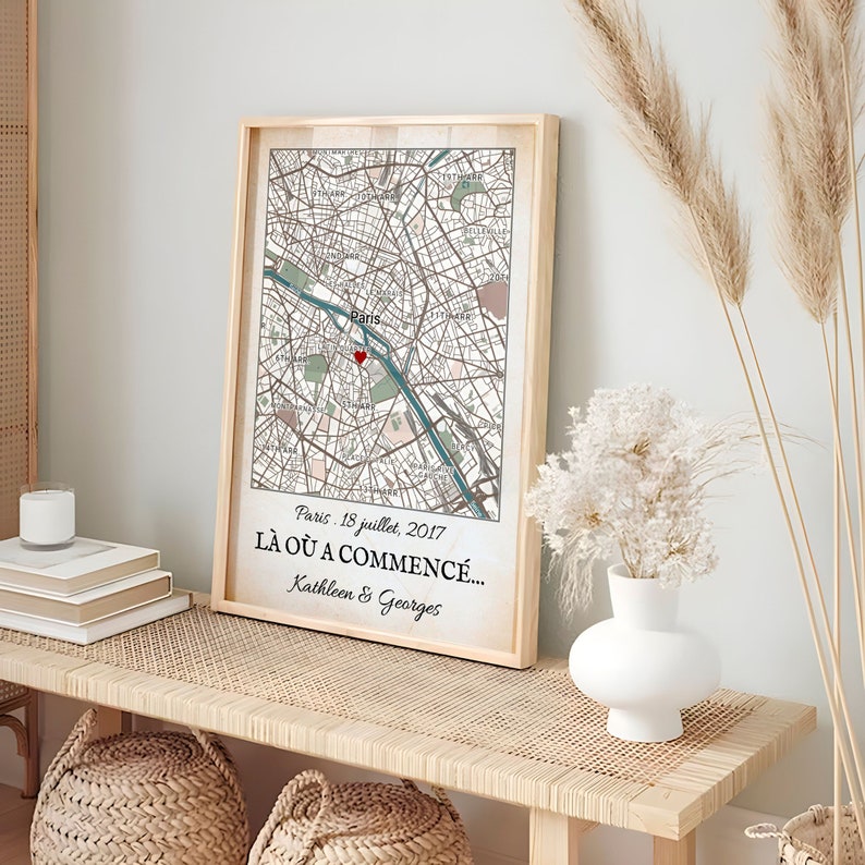May include: Framed map print of Paris, France, with a red heart marking a location. The print includes the text "Paris. 18 juillet, 2017 L&Agrave; O&Ugrave; A COMMENC&Eacute;... Kathleen & Georges" in a wooden frame.
