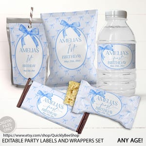 May include: A collection of party favors, including a water bottle, candy bars, and snack bags, all adorned with a light blue bow design and the text "Amelia's 1st Birthday." The set is designed for a birthday celebration.