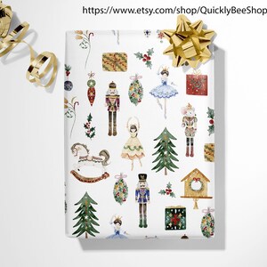 May include: White wrapping paper with a repeating pattern of watercolor illustrations of a nutcracker, a ballerina, a rocking horse, a Christmas tree, a birdhouse, and a Christmas wreath. The illustrations are in shades of red, green, blue, gold, and brown.