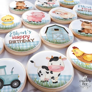 May include: A set of 10 farm animal themed sugar cookies decorated with blue and white gingham patterns. The cookies feature a variety of animals including a cow, pig, chicken, sheep, horse, and a tractor. The cookies are decorated with the text "Ethan's First Birthday" and "Ethan's Happy Birthday".