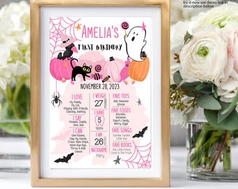May include: A framed, pink and orange Halloween-themed first birthday sign for Amelia. The sign includes a witch, black cat, ghost, pumpkins, spiderwebs, and the text "Amelia's First Birthday". It lists her weight as 27 pounds and height as 26 inches.